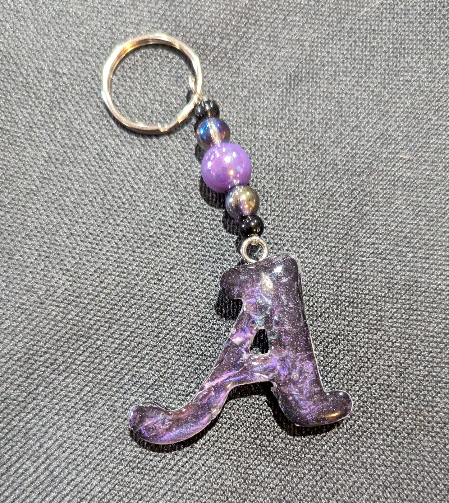 A letter purple beaded keychain